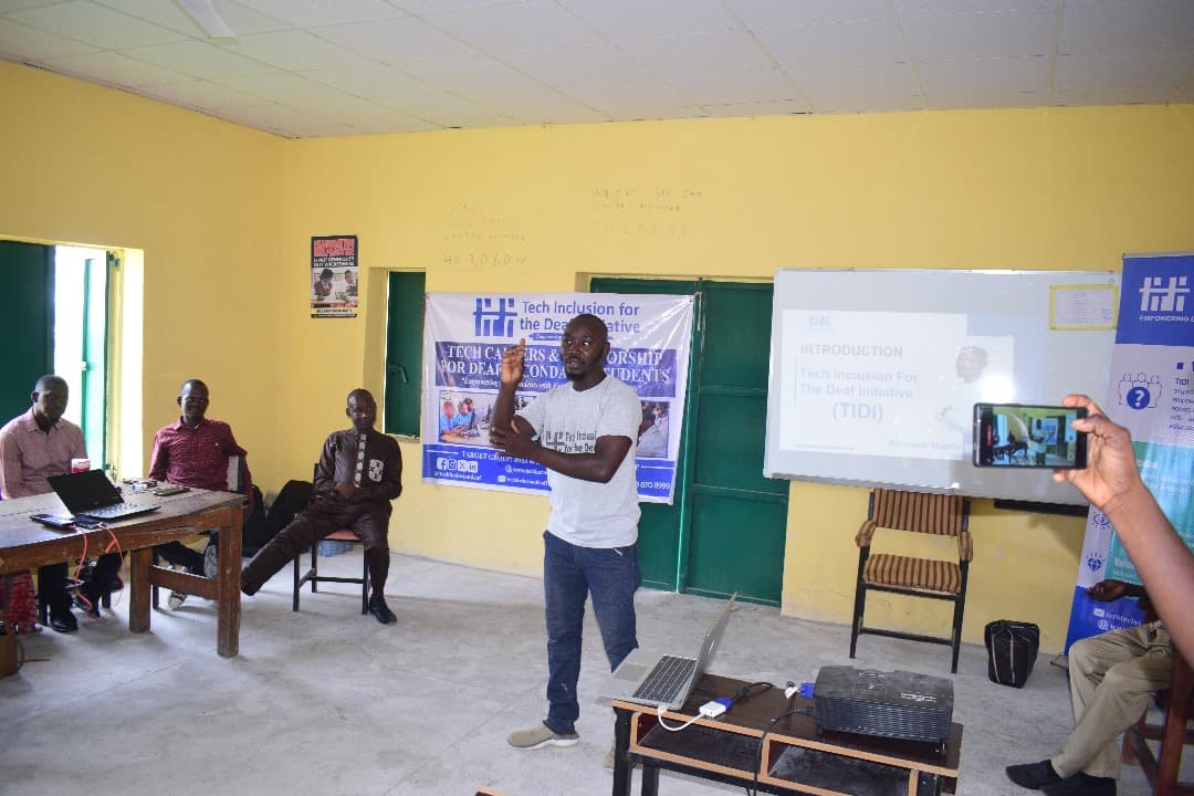 Trainer teaching signing students